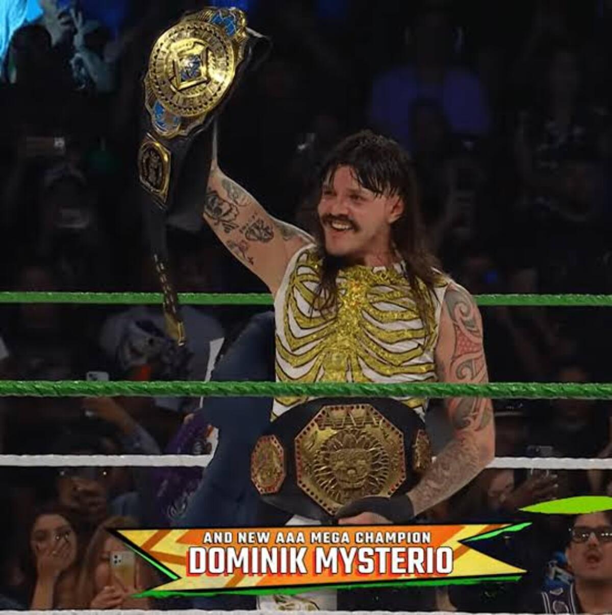 Dominik Mysterio celebrating with the AAA Mega Championship after his win at Worlds Collide 2025.
