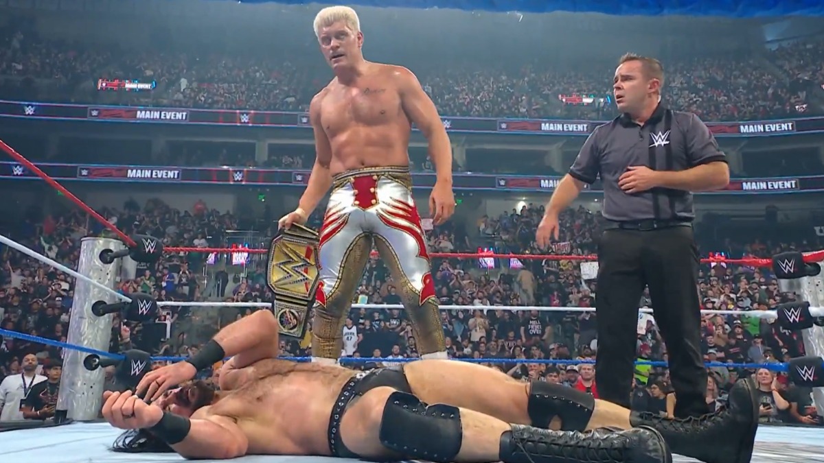 कोडी रोड्स WWE अनडिस्प्यूटेड चैंपियनशिप के साथ रिंग में जीत का जश्न मनाते हुए।